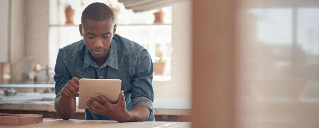 black man looking at tablet screen